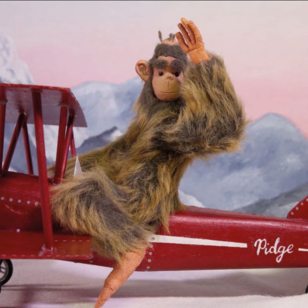 Animation of a monkey sitting on a red plane and waving